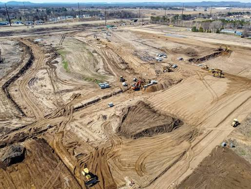 Aerial view of a residential site undergoing grading and infrastructure work